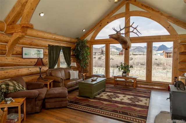 a living room with furniture fireplace and a large window