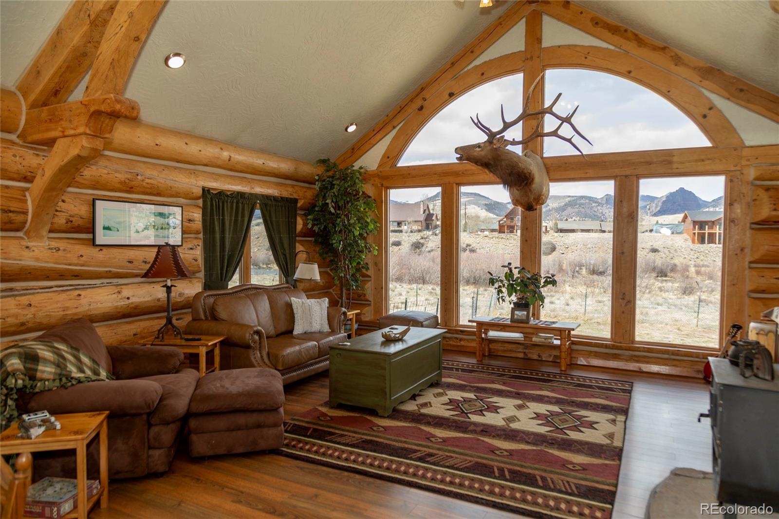 108 Forest Road, Unit 552 Creede, CO 81130 - Photo 11 of 32 a living room with furniture fireplace and a large window