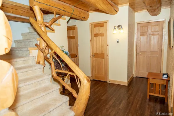 a view of an entryway with wooden floor and stairs