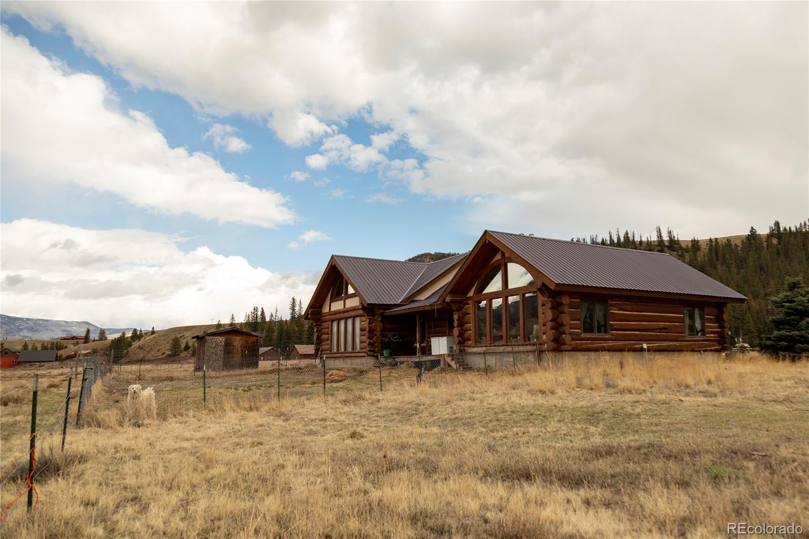 108 Forest Road, Unit 552 Creede, CO 81130 - Photo 5 of 32 a view of a large house with a big yard next to a lake
