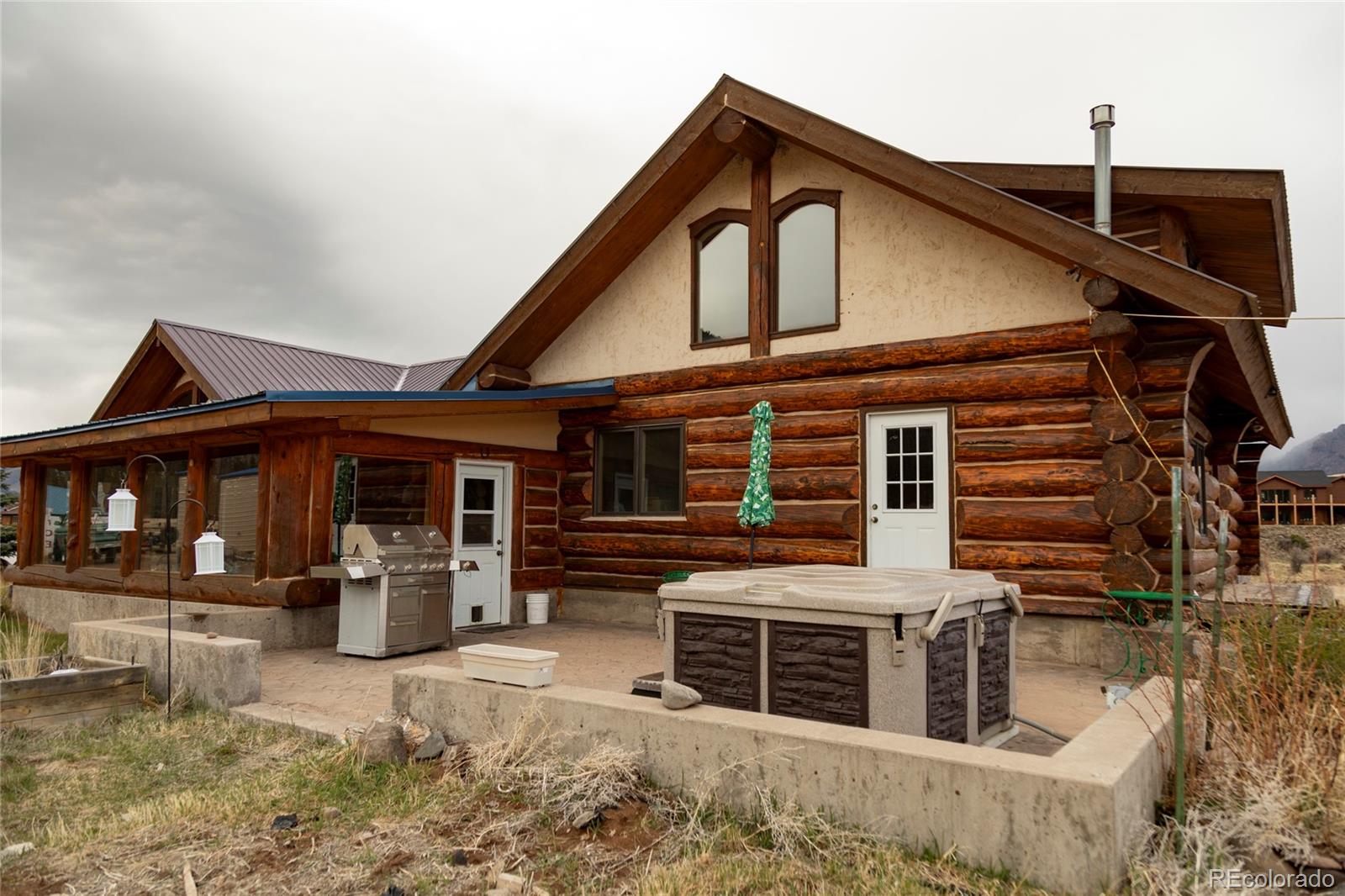 108 Forest Road, Unit 552 Creede, CO 81130 - Photo 10 of 32 a front view of a house with barbeque and wooden fence