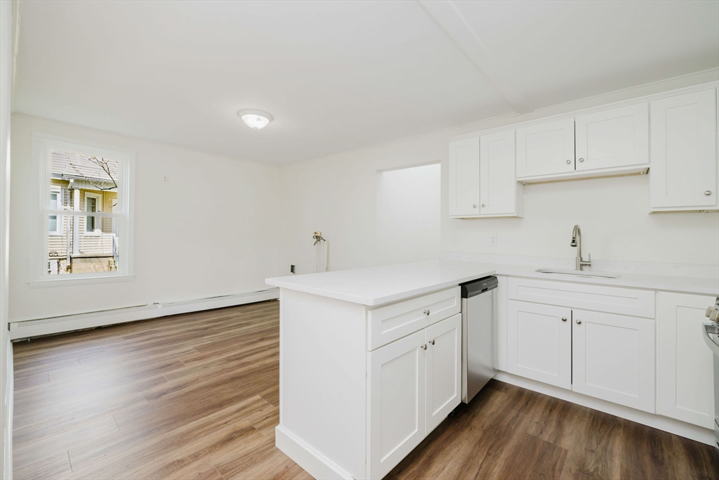 194 Albion Street Fall River, MA 02723 - Photo 16 of 42 a kitchen with cabinets wooden floor and a sink
