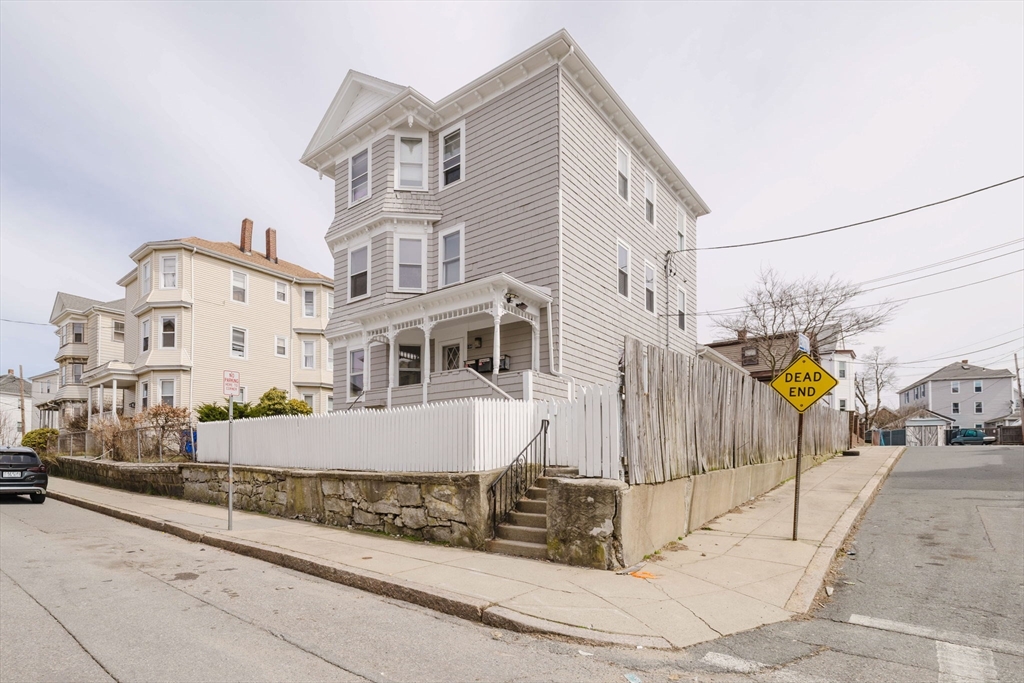 194 Albion Street Fall River, MA 02723 - Photo 2 of 42 a view of a white building with wooden fence
