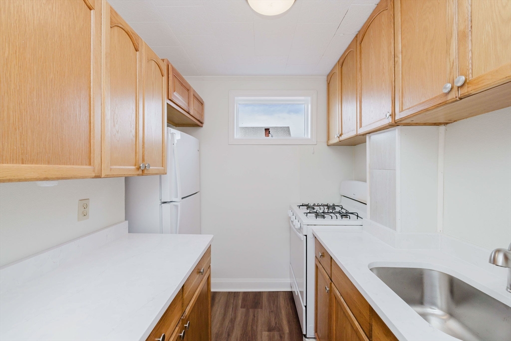 194 Albion Street Fall River, MA 02723 - Photo 32 of 42 a kitchen with stainless steel appliances granite countertop a sink stove and refrigerator