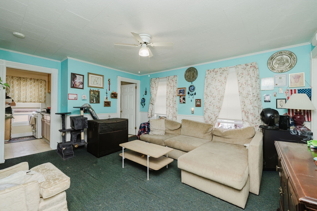 194 Albion Street Fall River, MA 02723 - Photo 37 of 42 a living room with furniture a clock on wall and a window