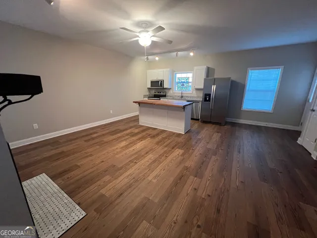 a view of workspace with wooden floor and ceiling fan