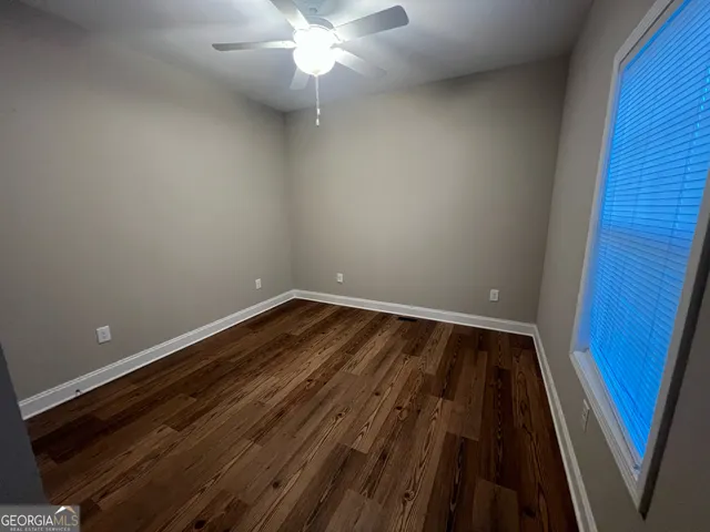 en empty room with wooden floor