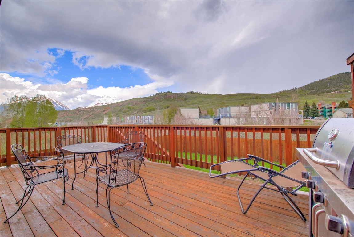 231 Alpine Road Dillon, CO 80435 - Photo 11 of 40 a view of a chairs on wooden deck with a lake