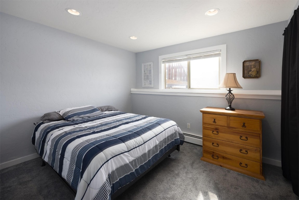 231 Alpine Road Dillon, CO 80435 - Photo 15 of 40 a bedroom with a bed and a window