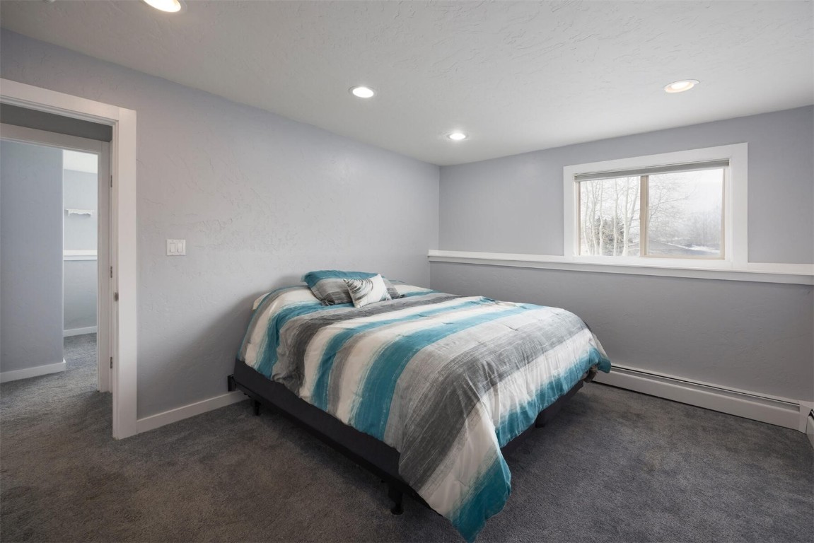 231 Alpine Road Dillon, CO 80435 - Photo 17 of 40 a bed sitting in a spacious bedroom next to a window