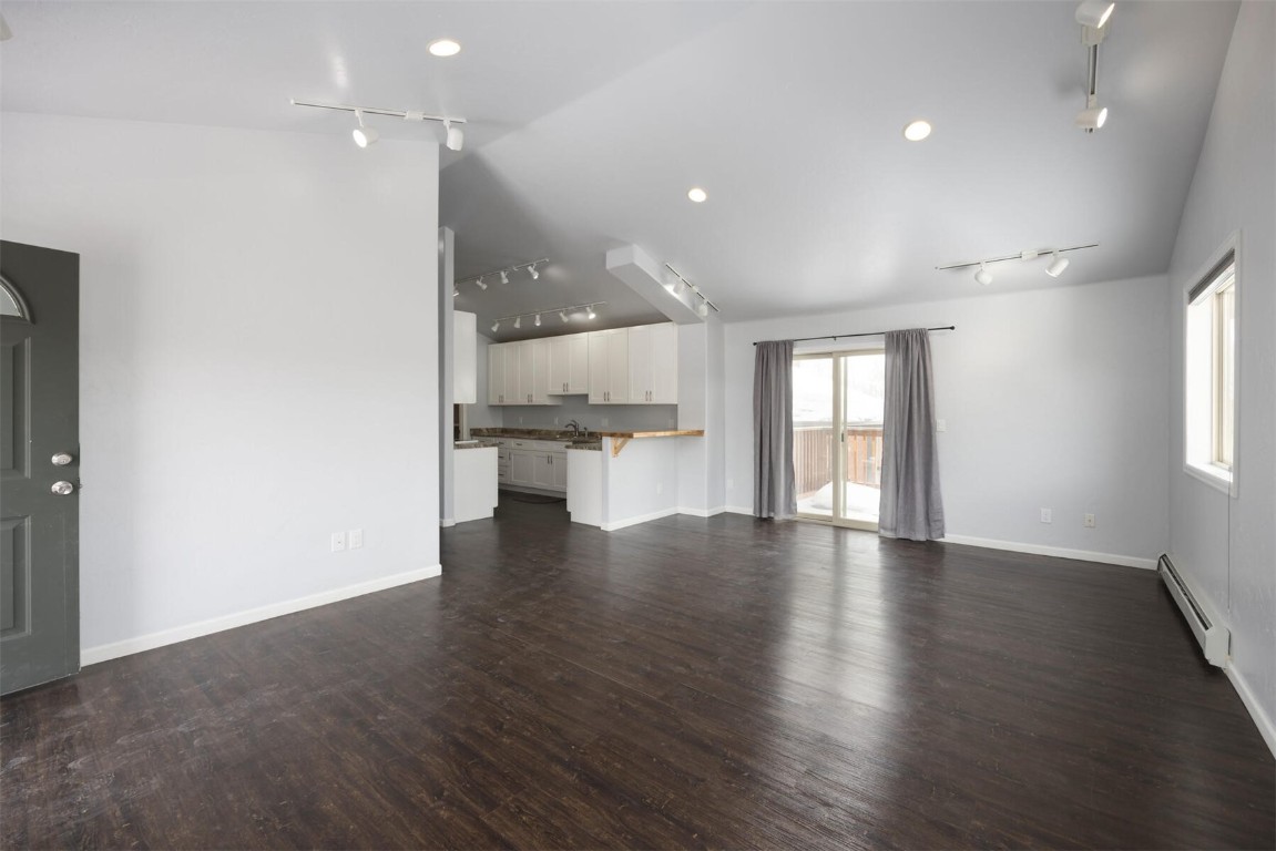 231 Alpine Road Dillon, CO 80435 - Photo 25 of 40 a view of an empty room with wooden floor and a window