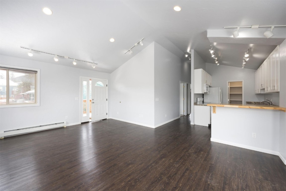 231 Alpine Road Dillon, CO 80435 - Photo 26 of 40 an empty room with wooden floor and windows