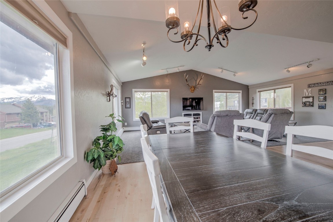 231 Alpine Road Dillon, CO 80435 - Photo 7 of 40 a view of dining room and livingroom with furniture wooden floor a chandelier