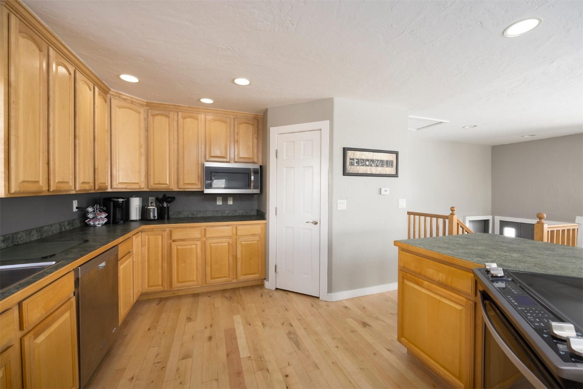 231 Alpine Road Dillon, CO 80435 - Photo 10 of 40 a kitchen with stainless steel appliances granite countertop a stove a sink and a refrigerator