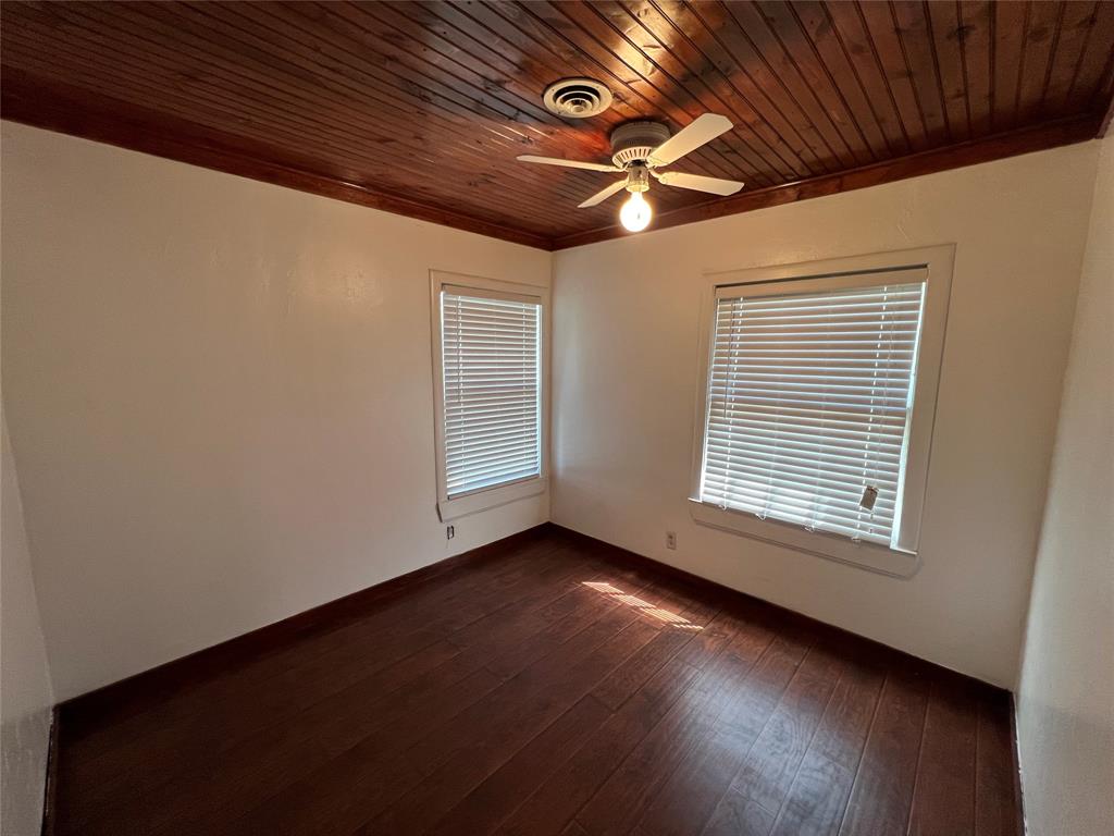 533 East Sears Street Denison, TX 75021 - Photo 15 of 27 a view of an empty room with wooden floor and a window