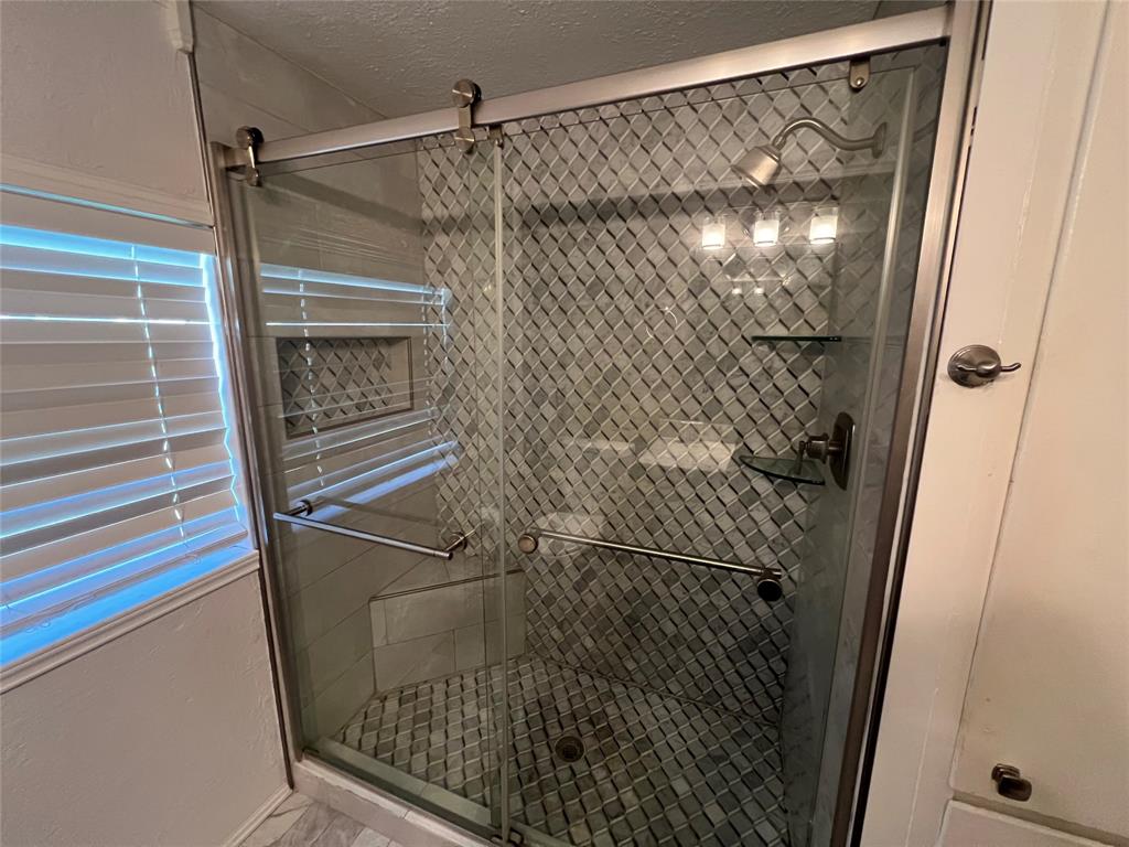 533 East Sears Street Denison, TX 75021 - Photo 19 of 27 a bathroom with a glass door shower and a sink