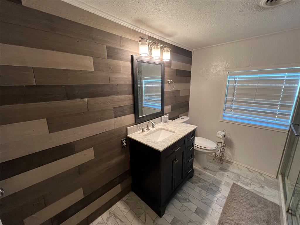 533 East Sears Street Denison, TX 75021 - Photo 20 of 27 a bathroom with a sink and mirror