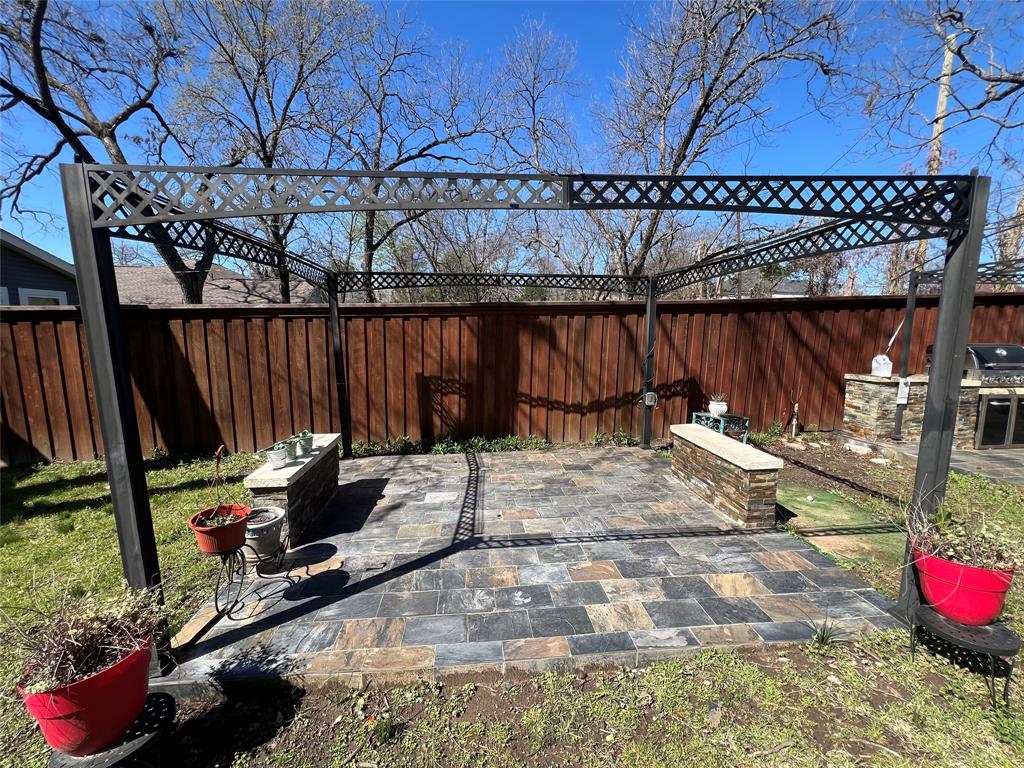 533 East Sears Street Denison, TX 75021 - Photo 23 of 27 a view of a backyard with table and chairs potted plants