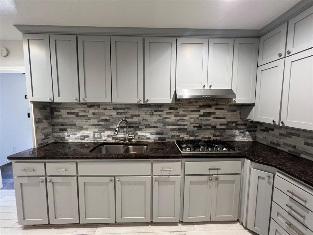533 East Sears Street Denison, TX 75021 - Photo 8 of 27 a view of a kitchen with granite countertop cabinets