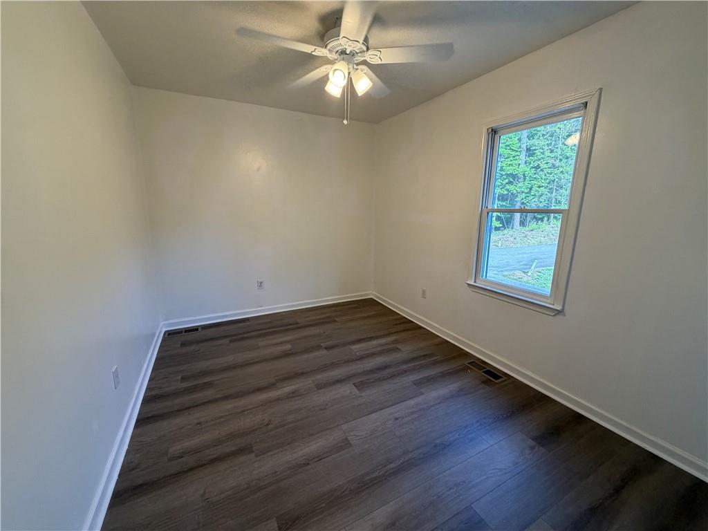 86 Robert Jones Road Dawsonville, GA 30534 - Photo 7 of 19 wooden floor in an empty room with a window