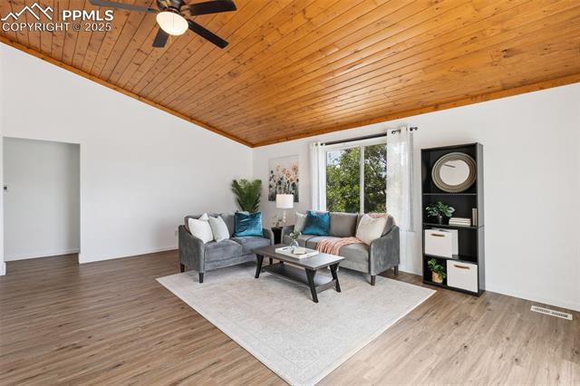 10925 Double D Road Fountain, CO 80817 - Photo 12 of 33 Living area with wood ceiling, a ceiling fan, vaulted ceiling, and wood finished floors