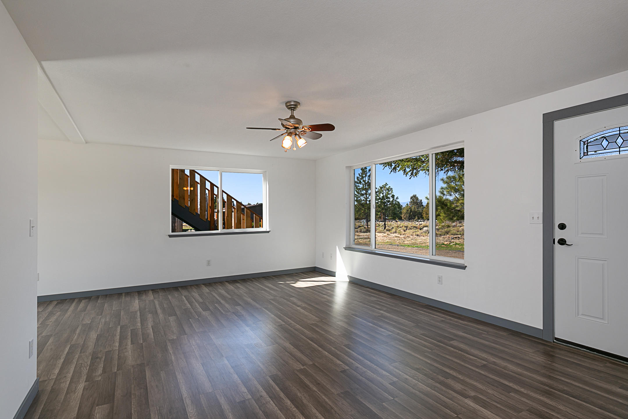 65158 Hunnell Road Bend, OR 97703 - Photo 3 of 31 a view of an empty room with wooden floor and a window