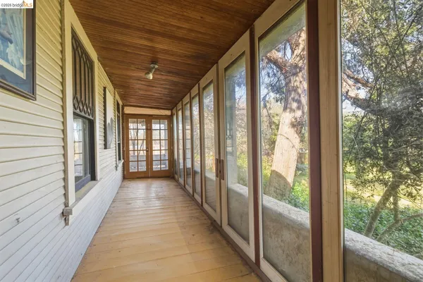 a view of a porch with wooden floor and stairs