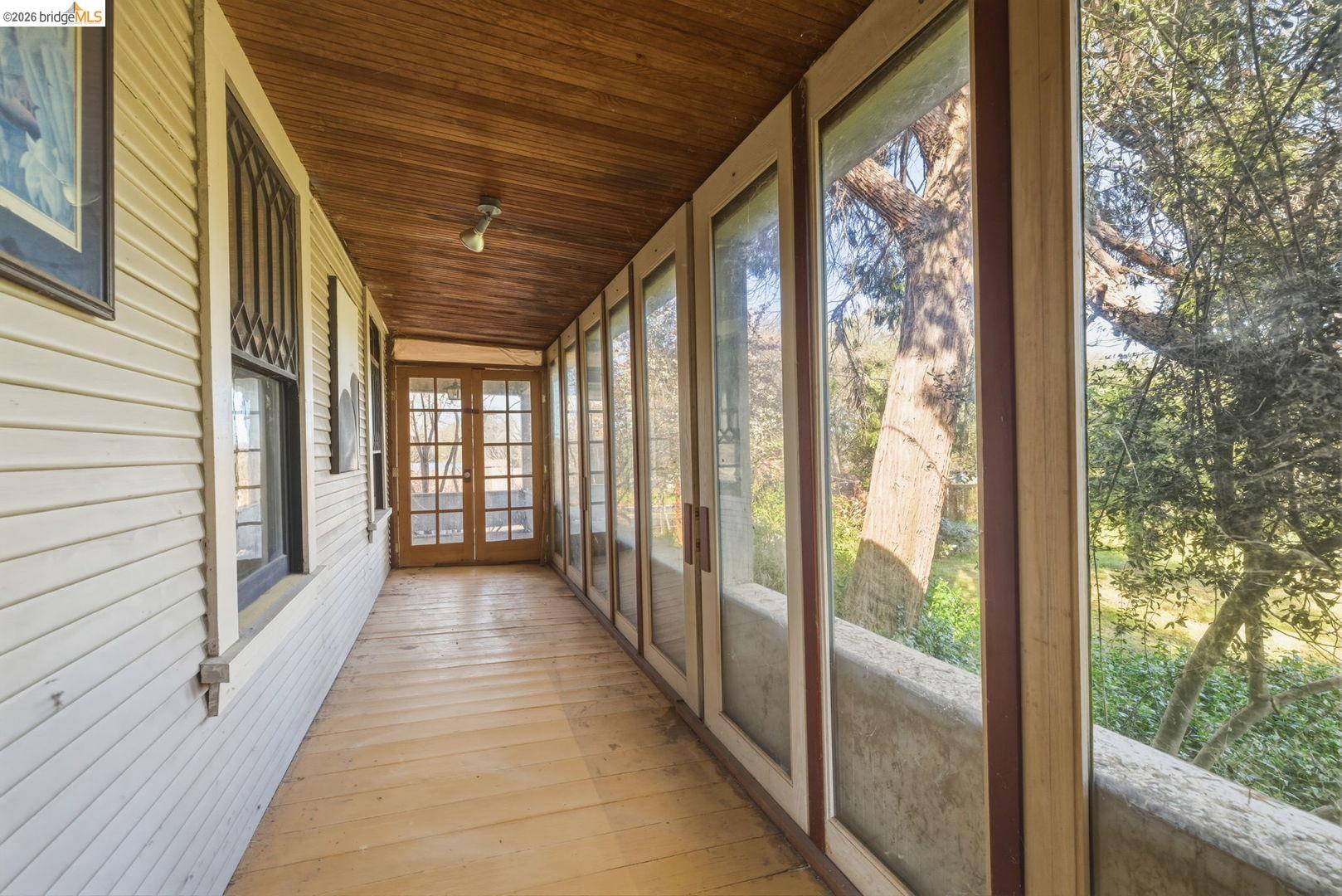 16129 Jacksonville Road Jamestown, CA 95327 - Photo 14 of 39 a view of a porch with wooden floor and stairs