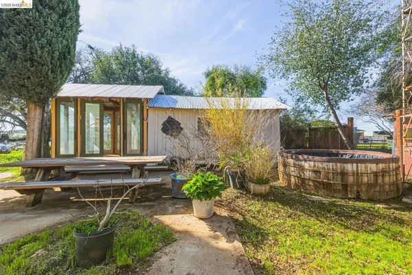 a view of a house with backyard and sitting area