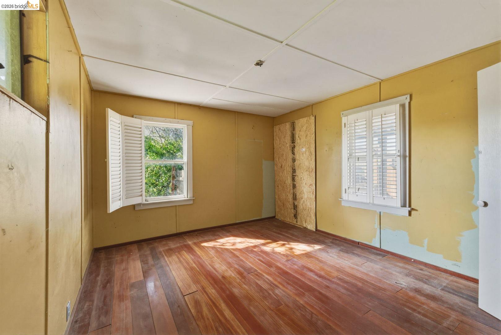 16129 Jacksonville Road Jamestown, CA 95327 - Photo 34 of 39 a view of an empty room with wooden floor and a window