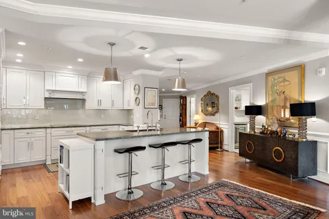 a open kitchen with stainless steel appliances granite countertop a stove a sink dishwasher and cabinets with wooden floor