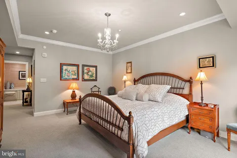 a bedroom with a bed and a chandelier