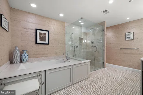 a bathroom with a double vanity sink mirror and shower