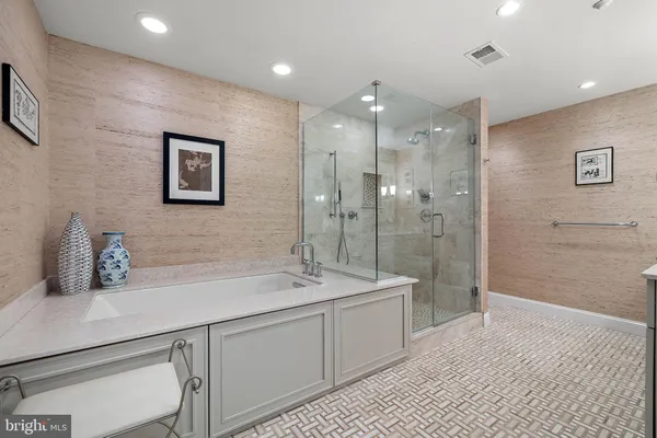 a bathroom with a double vanity sink mirror and shower