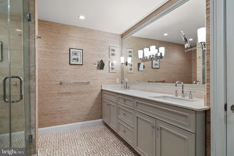 a bathroom with a sink a shower and a mirror