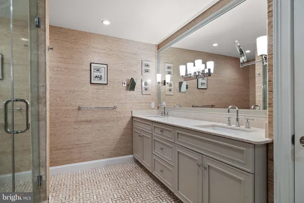 a bathroom with a sink a shower and a mirror