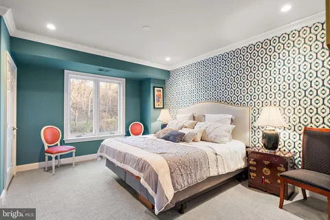 a bedroom with two beds and a chair