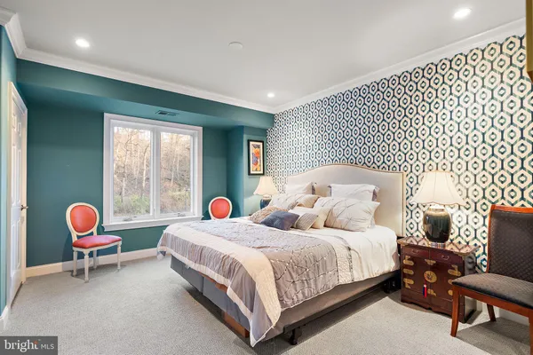 a bedroom with two beds and a chair