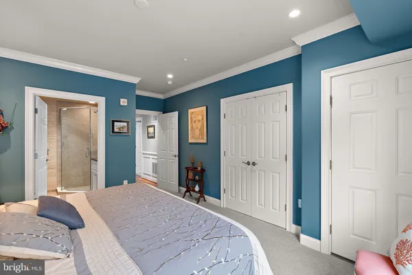 a bedroom with a large bed and walk in closet