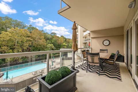 a view of a chairs and table in the balcony
