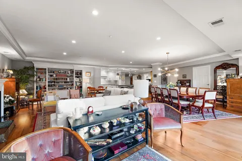 a living room with lots of furniture and clutter