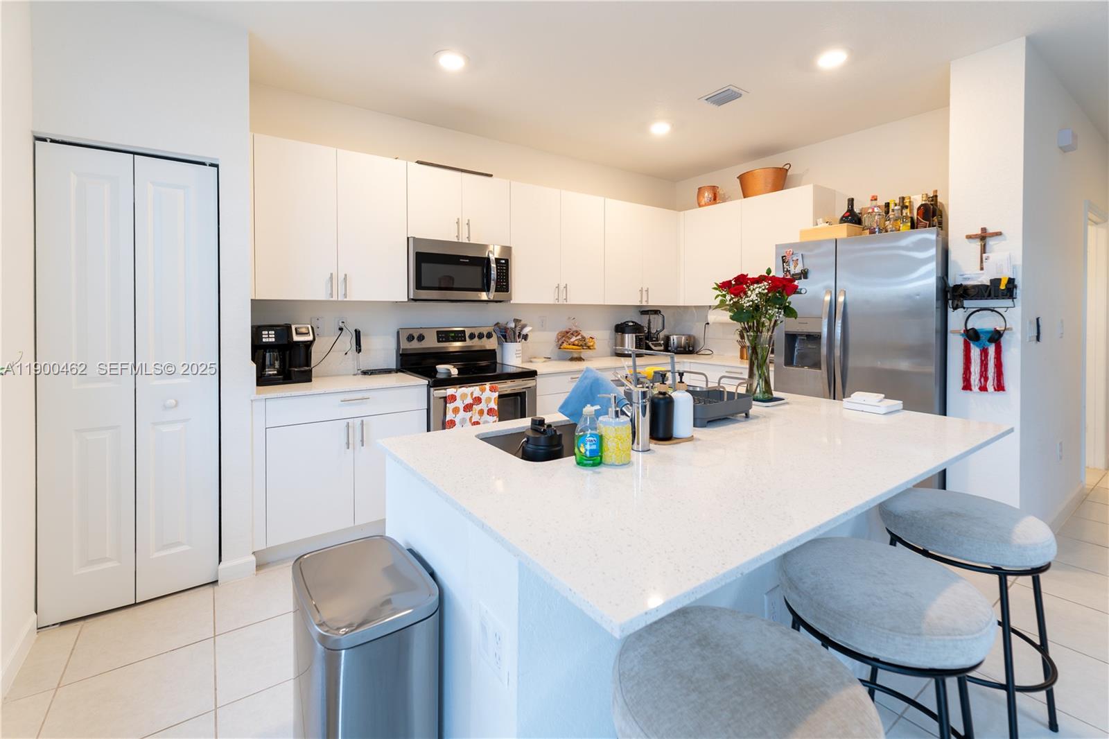 13132 Southwest 234th Terrace Homestead, FL 33032 - Photo 11 of 24 a kitchen with stainless steel appliances granite countertop a sink a stove a refrigerator and cabinets