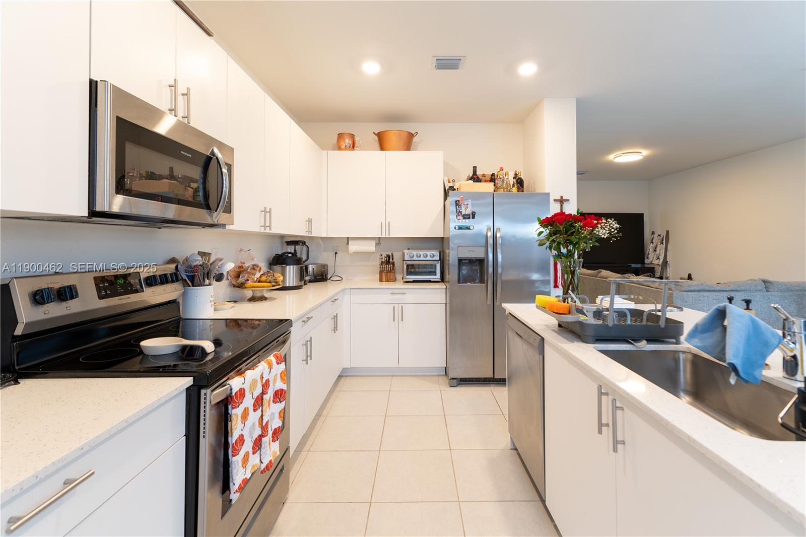 13132 Southwest 234th Terrace Homestead, FL 33032 - Photo 14 of 24 a kitchen that has a lot of cabinets in it and appliances