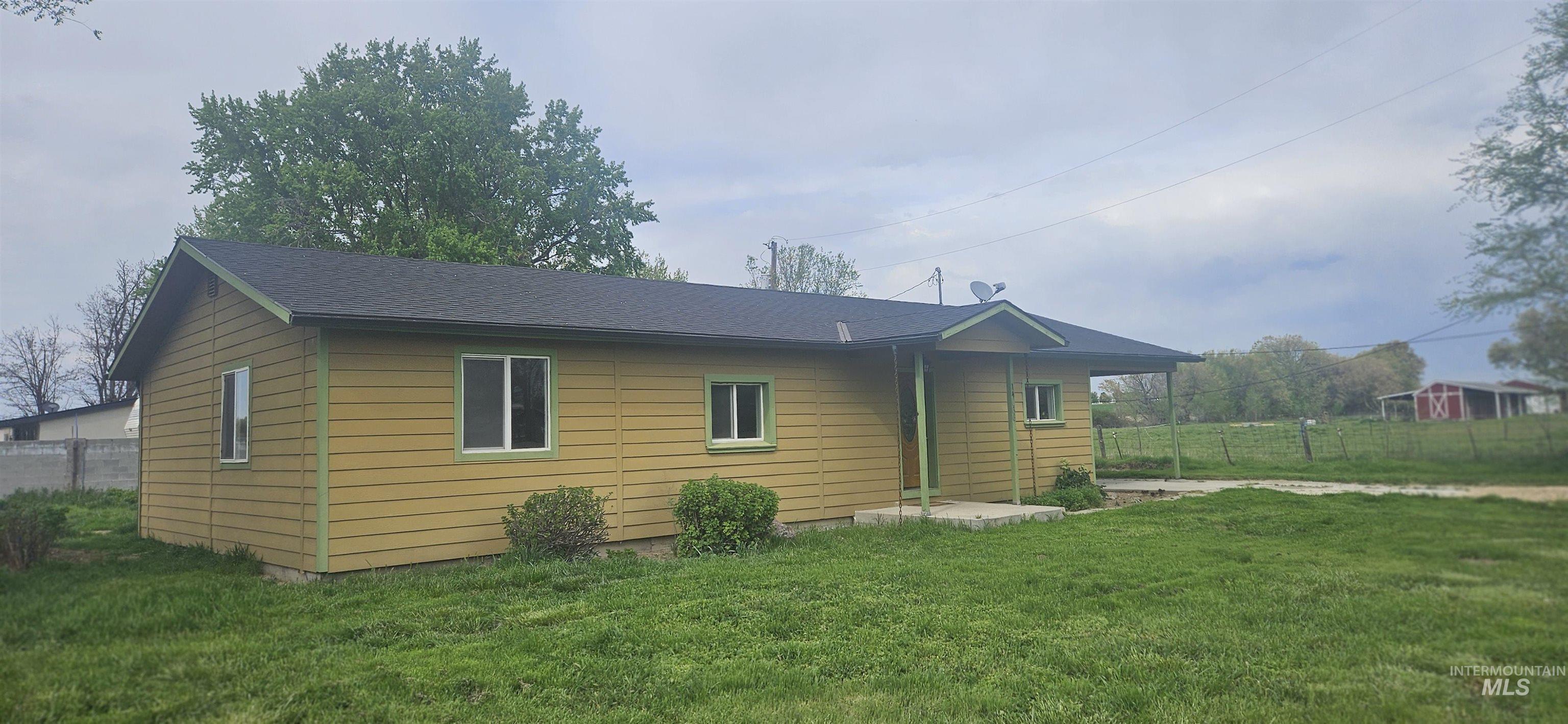 Single-story residence with an irrigated pasture. Apx 1 acre.