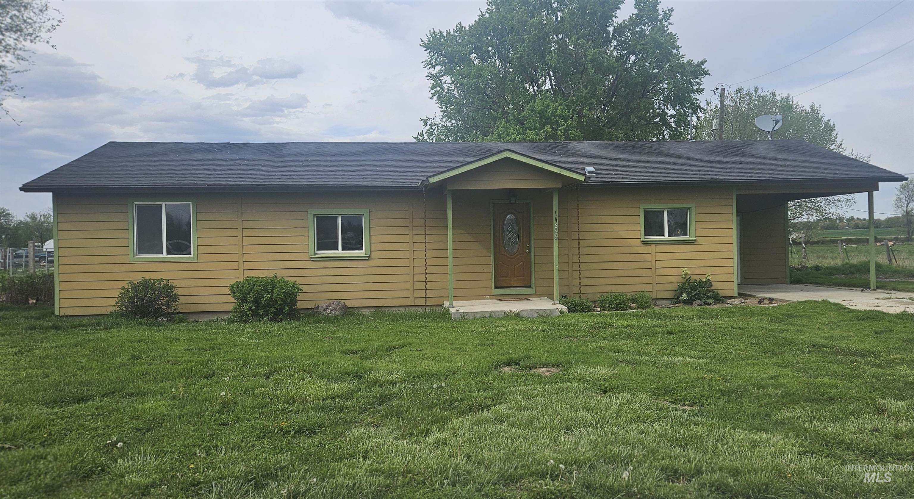 14666 Willis Road Caldwell, ID 83607 - Photo 2 of 23 Single-story residence featuring horizontal siding, a dark shingle roof, and a covered entry