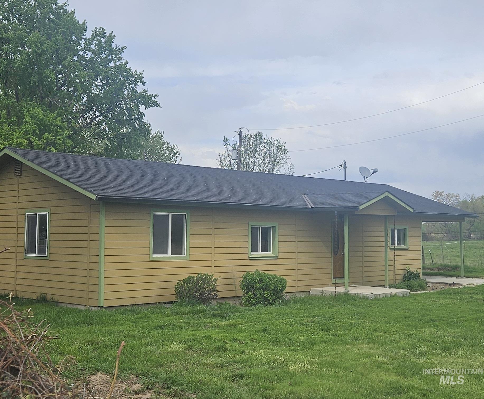 14666 Willis Road Caldwell, ID 83607 - Photo 3 of 23 Single-story residence featuring horizontal siding, a dark shingle roof, and light green trim