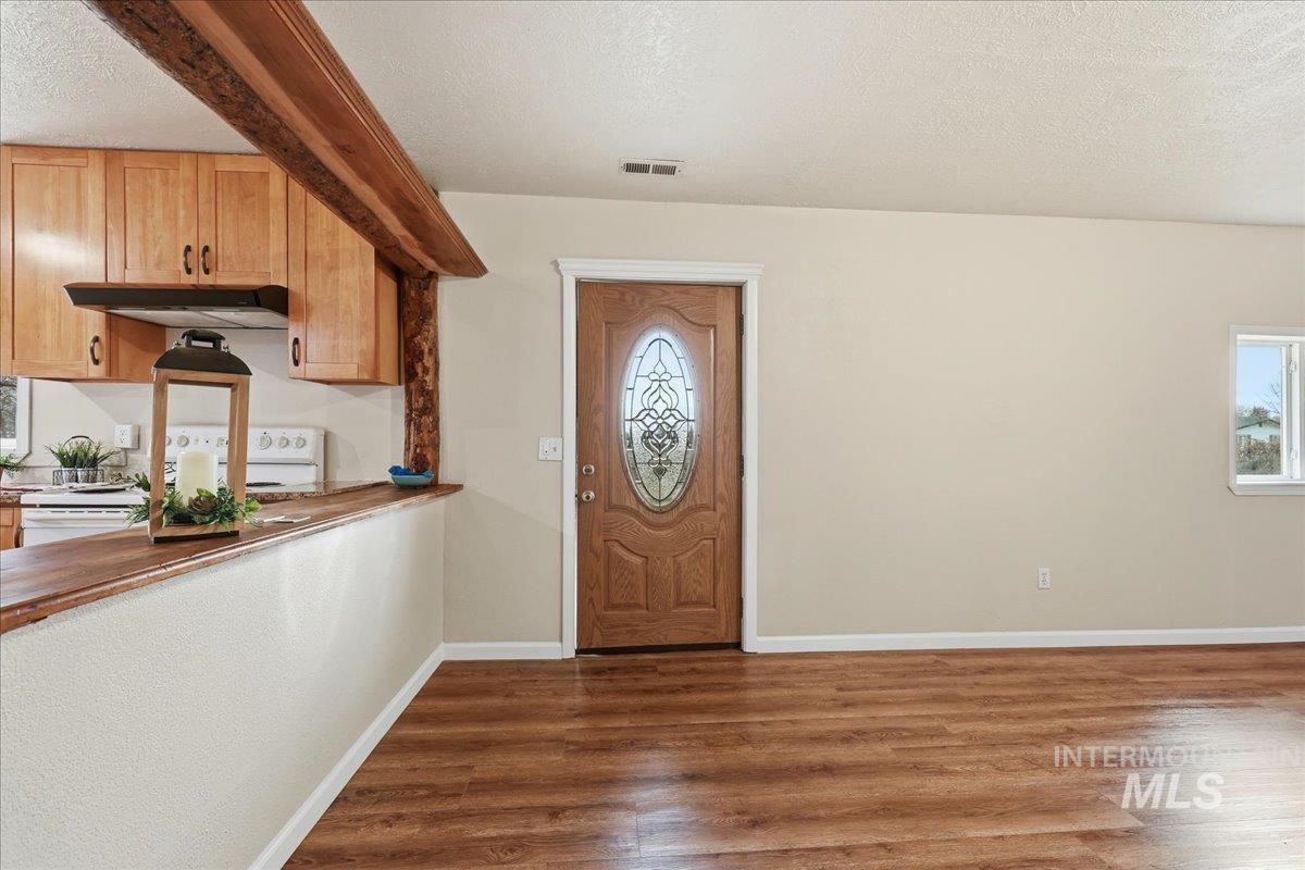 14666 Willis Road Caldwell, ID 83607 - Photo 4 of 23 Entryway featuring dark wood-style floors and a textured ceiling