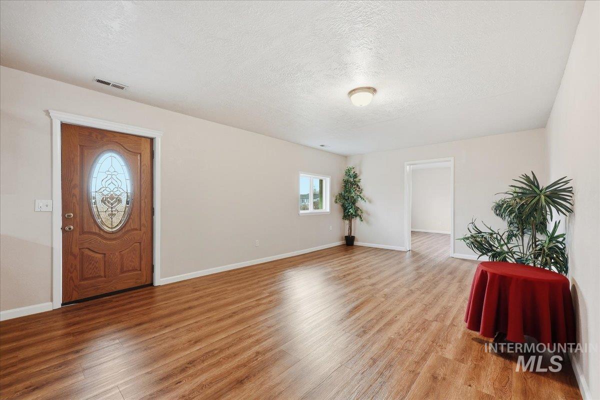 14666 Willis Road Caldwell, ID 83607 - Photo 9 of 23 Entrance foyer with a textured ceiling and light wood-style flooring