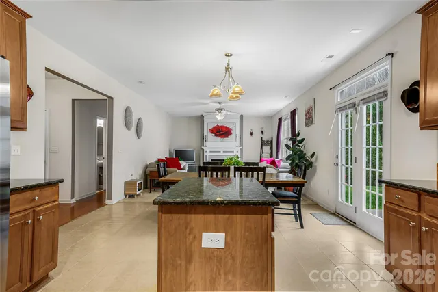 a view of a dining room with furniture and a chandelier