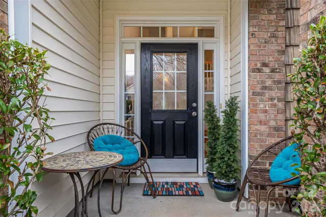 a front view of a house with outdoor seating and plants